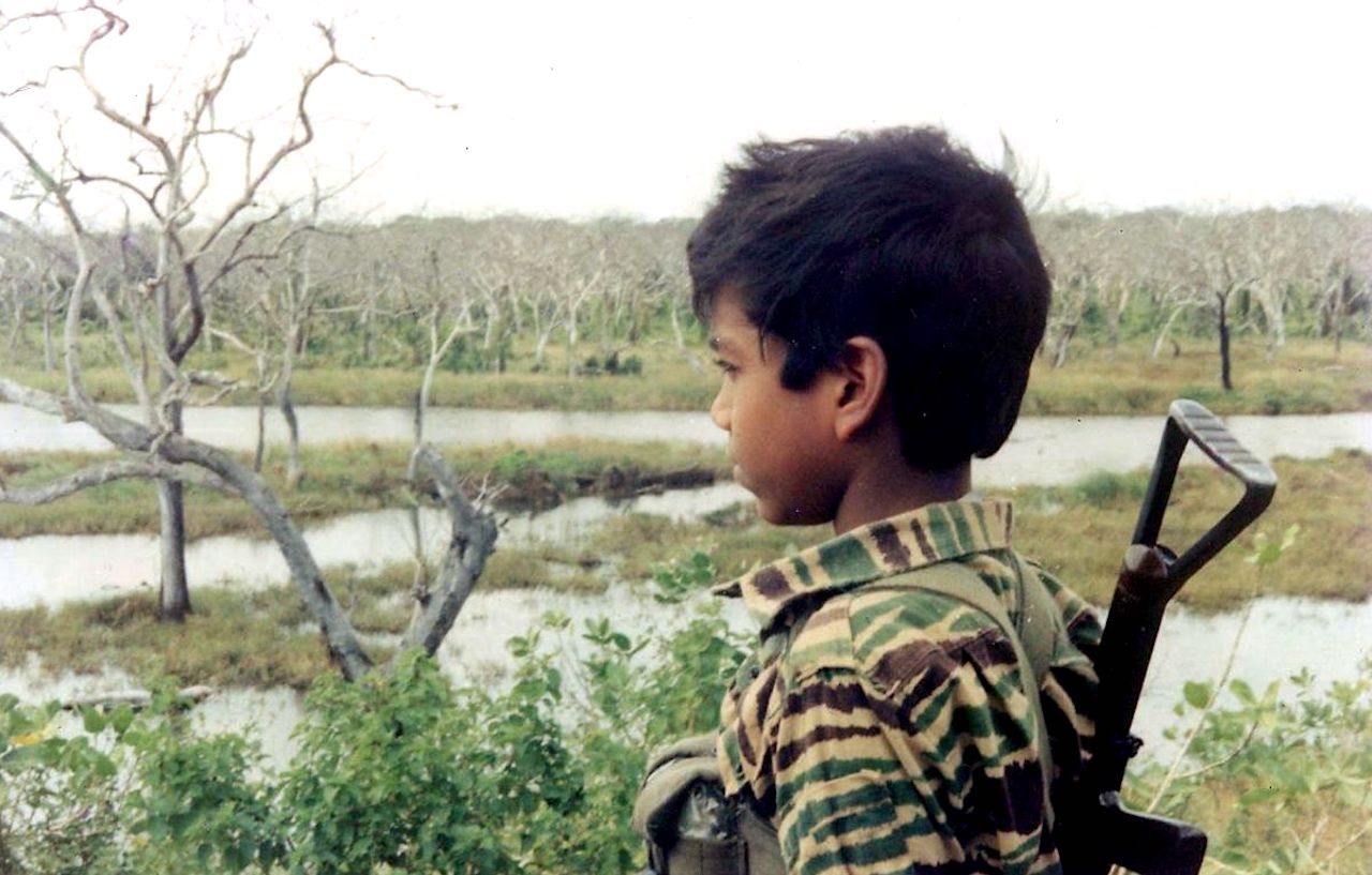 An undated picture supplied by the Sri Lankan Ministry of Defence from a collection of photographs that government soldiers said were discovered recently in a "hideout" in northern Sri Lanka, shows a boy dressed in a Liberation Tigers of Tamil Eelam (LTTE) uniform and carrying a gun over his shoulder. The government said recently that operations to finish Asia's longest-running war would not let up, adding troops were moving toward the rebel pocket where LTTE leader Vellupillai Prabhakaran is believed to be hiding. REUTERS/Sri Lankan Ministry of Defence/Handout (SRI LANKA MILITARY CONFLICT POLITICS) QUALITY FROM SOURCE. FOR EDITORIAL USE ONLY. NOT FOR SALE FOR MARKETING OR ADVERTISING CAMPAIGNS - GM1E55D16TD01