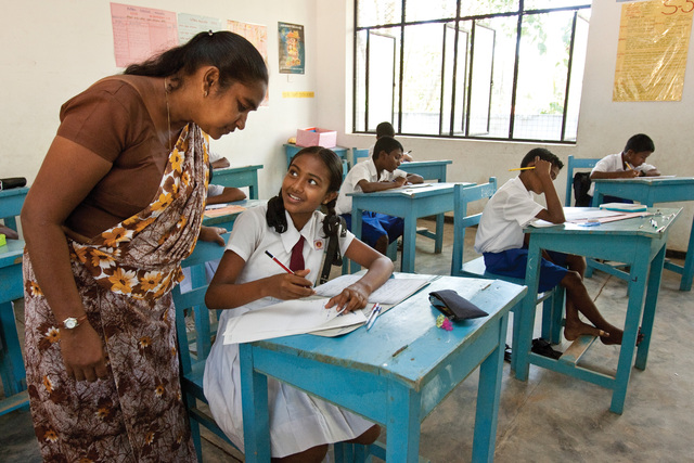 Students attend class at Moraketiara Kanishta Vidyalaya in Nakulugamuwa, Sri Lanka, one of 20 schools rebuilt through the Schools Reawaken project after the 2004 tsunami. The tsunami killed more than 30,000 people and displaced over 850,000 in Sri Lanka alone. District 3220, The Rotary Foundation, and Standard Chartered Bank supported the effort.